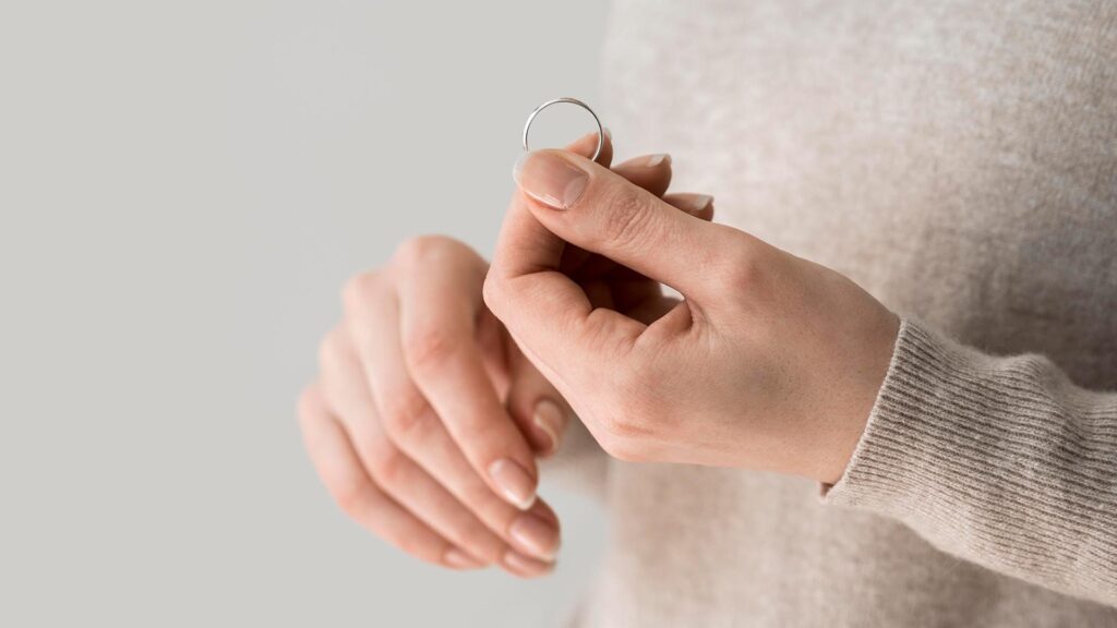 hands holding ring